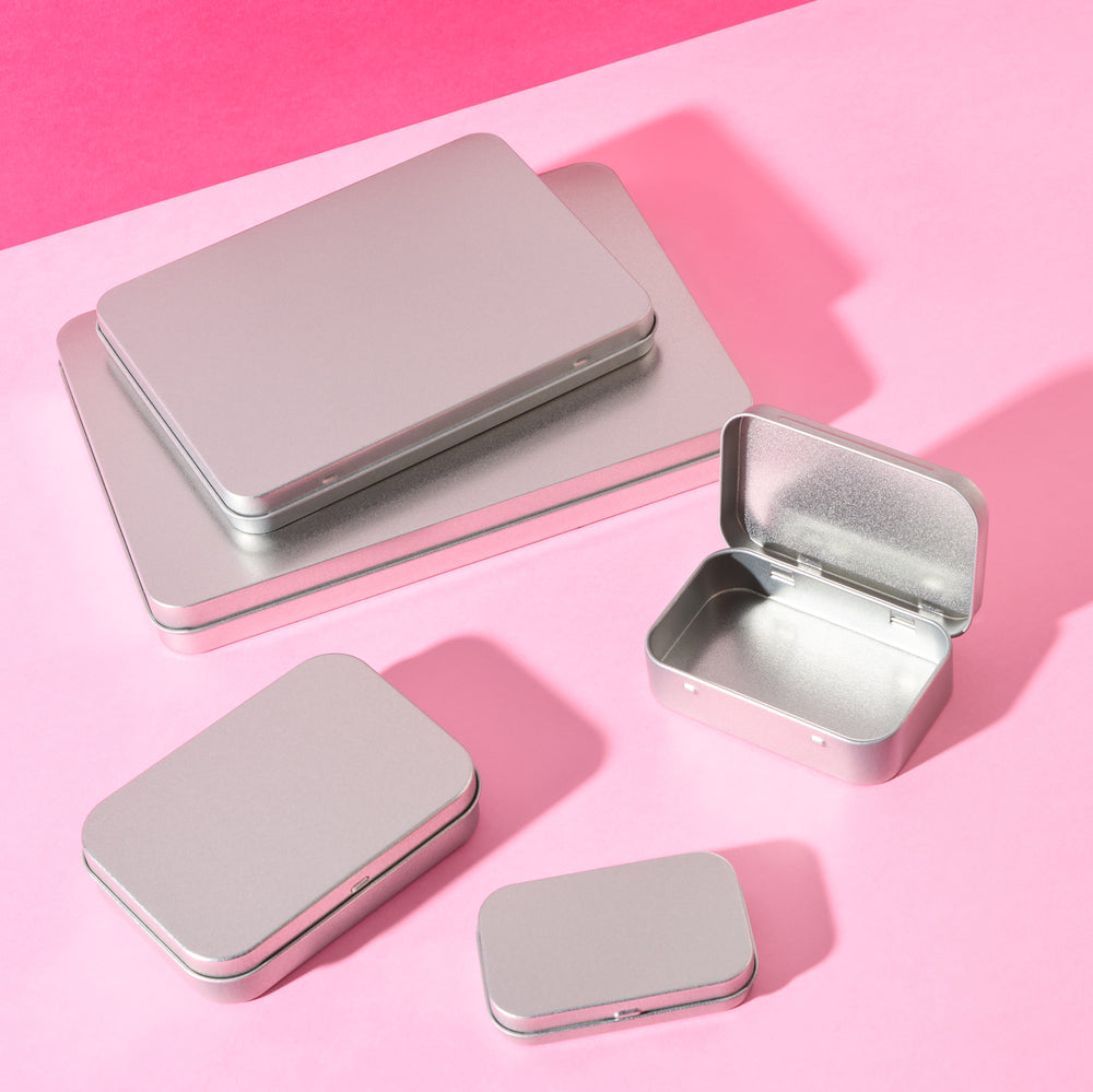 A collection of different sized rectangular stationery tins.